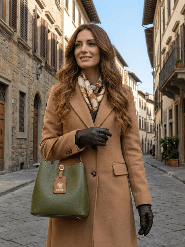 Woman with an elegant two-tone leather bag in green and brown