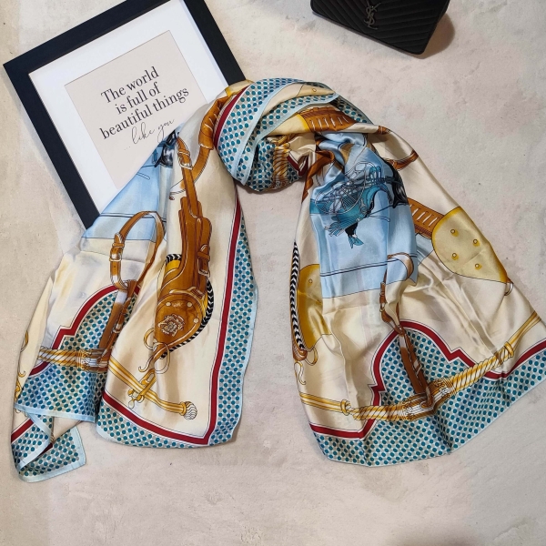 Folded luxurious light blue satin scarf with horse motifs and beige details from Unique Fashion