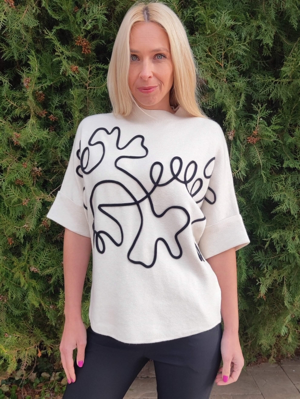 White women's short-sleeved sweater with abstract black applique, front view