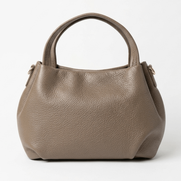 Front part of an elegant dark beige leather handbag with an embossed texture, elegant design and two short handles.