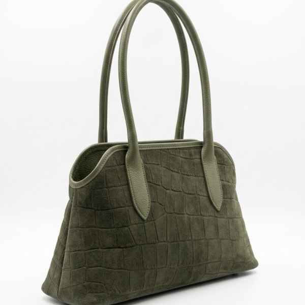 Side view of an elegant khaki suede shoulder bag with leather handles.