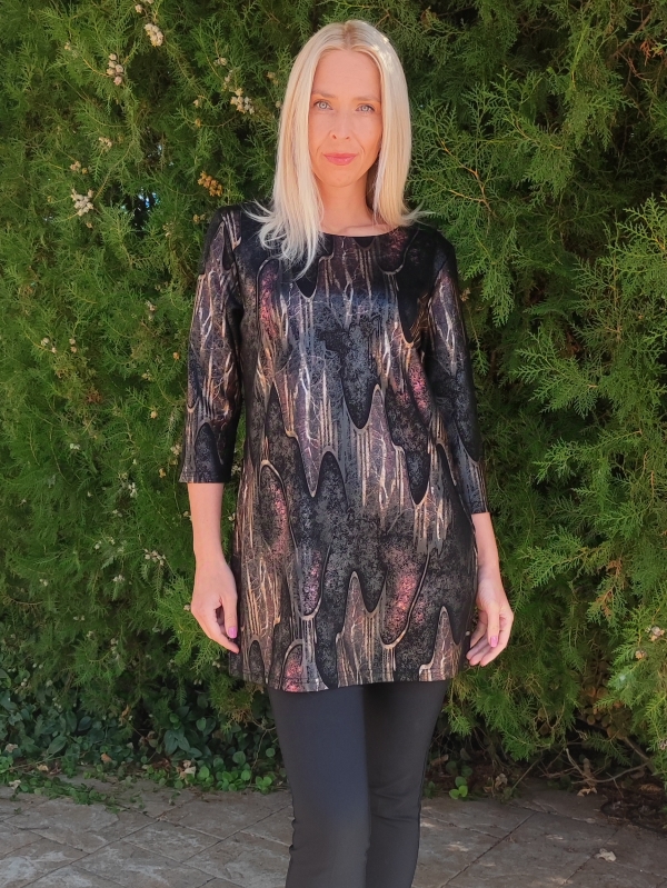 Woman wearing a black tunic with an abstract print