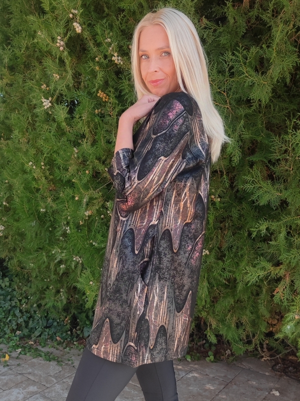 Woman wearing a black tunic with an abstract print