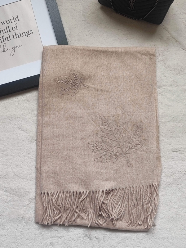 Women's beige alpaca and viscose scarf, folded, showing leaf embroidery.