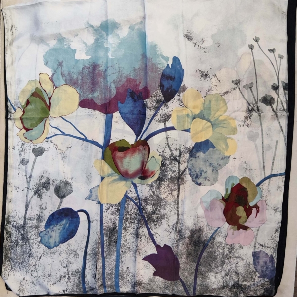 Texture of a white scarf with watercolor blue and purple flowers, close-up