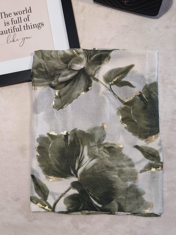 Folded luxurious viscose scarf with green flowers and gold threads.