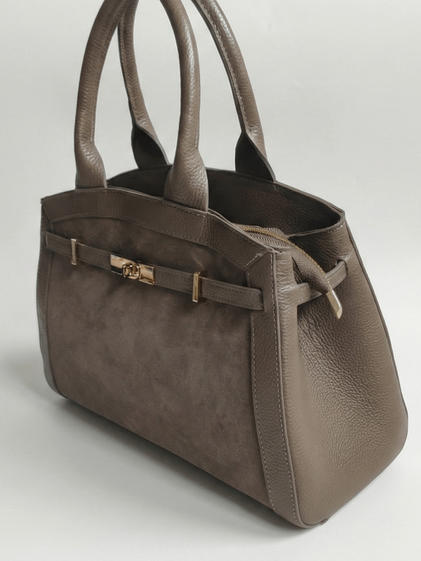 Luxurious handbag made of natural suede and leather with front gold fastening.