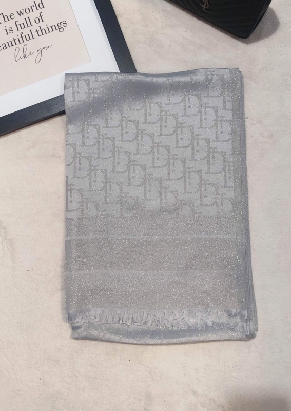 Folded luxurious silver scarf made of viscose and cotton with shiny thread.