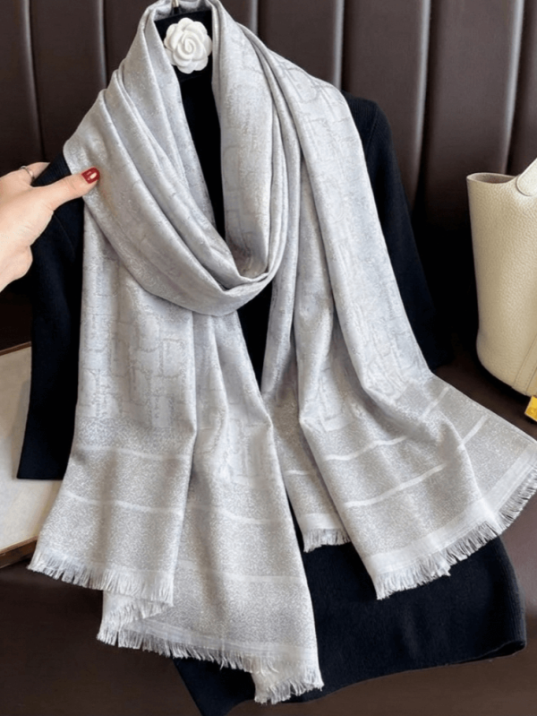 Elegant women's scarf in gray with a shiny effect and a designer print with letters.