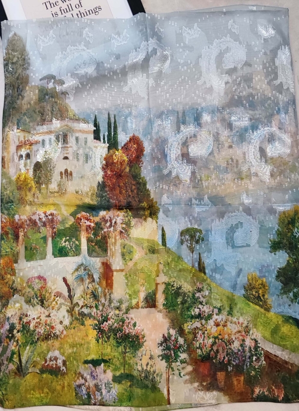 "A fine women's scarf with a print of an Italian villa and cypresses in Tuscany, unfolded."