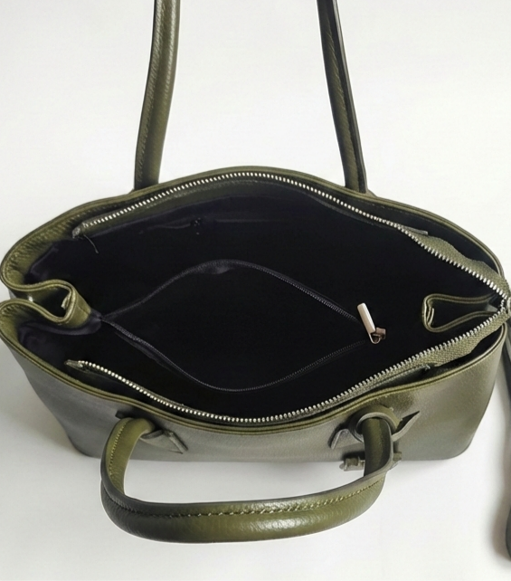 Interior layout of a green business bag with three compartments, black lining and zip pockets