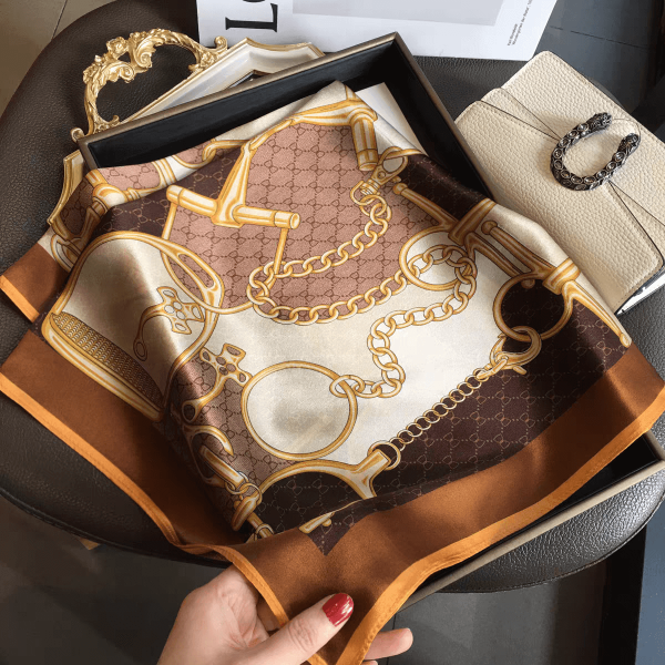 Квадратен сатенен шал 70х70 см с принт на златни орнаменти и кафеви акценти.