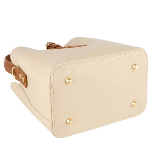 Bottom of a beige leather bag with metal protective feet