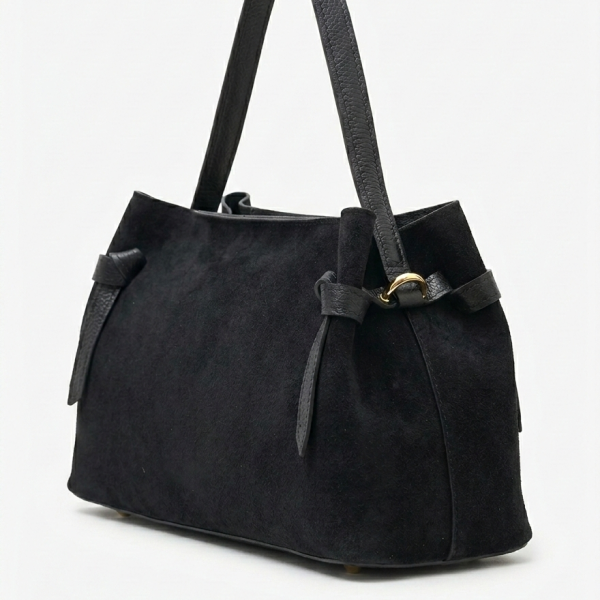 Side profile of a luxurious suede bag with golden brass details and high-quality Italian craftsmanship.