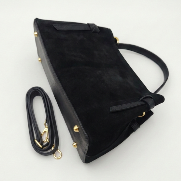 Black Italian handbag made of natural suede and leather with a detachable adjustable shoulder strap and gold metal feet.