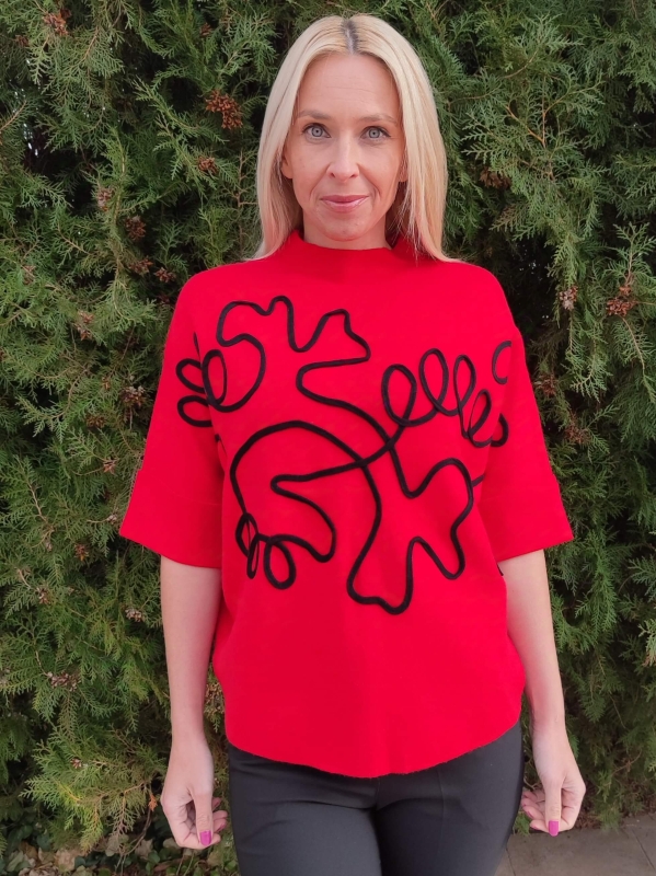 Red women's sweater with short sleeves and abstract black applique, front view