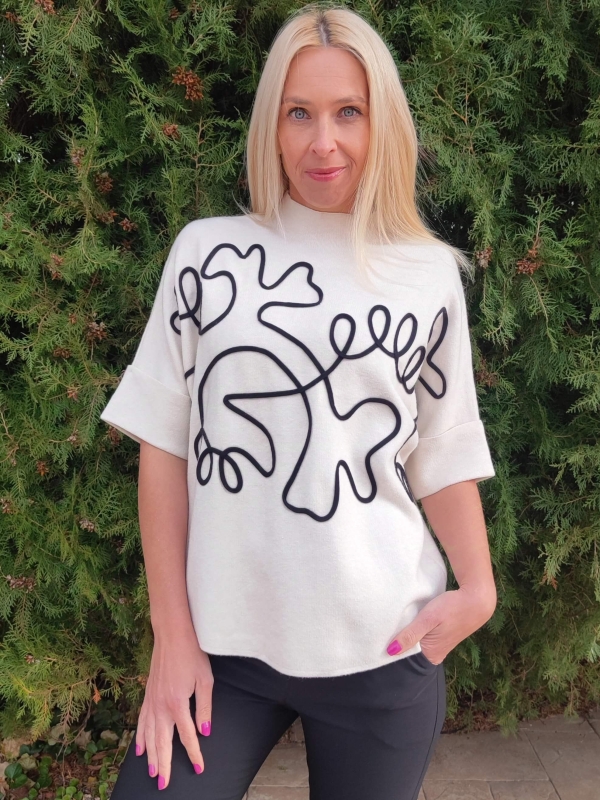 White women's short-sleeved sweater with abstract black applique, front view