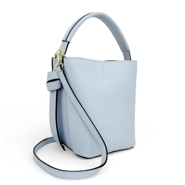 Side view (profile) of a light blue women's leather tote bag with a short handle and a carabiner for a long shoulder strap