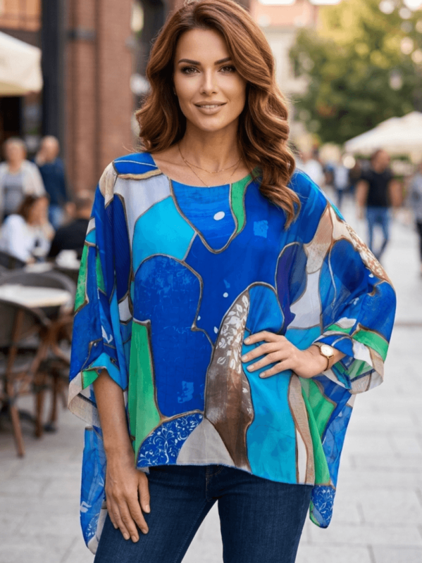 Elegant blue silk and viscose blouse in large sizes, combined with jeans.