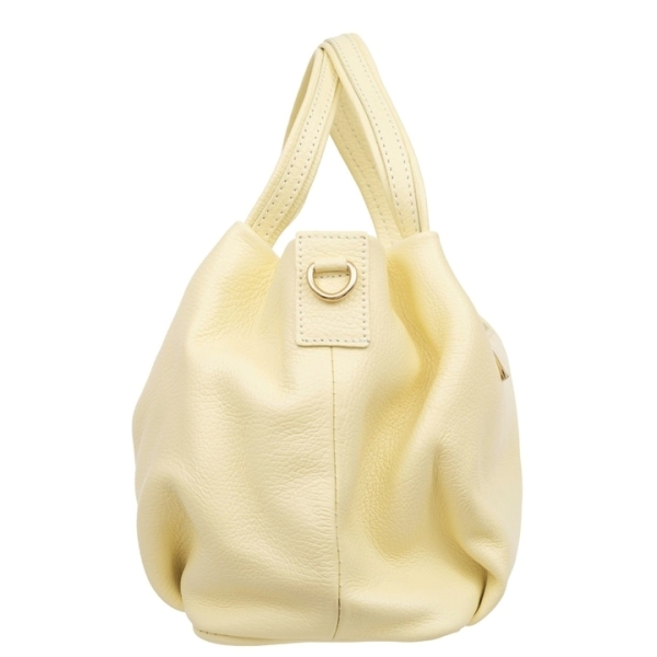 A side profile of the stylish handbag, highlighting its clean, soft structure and sturdy short handles.