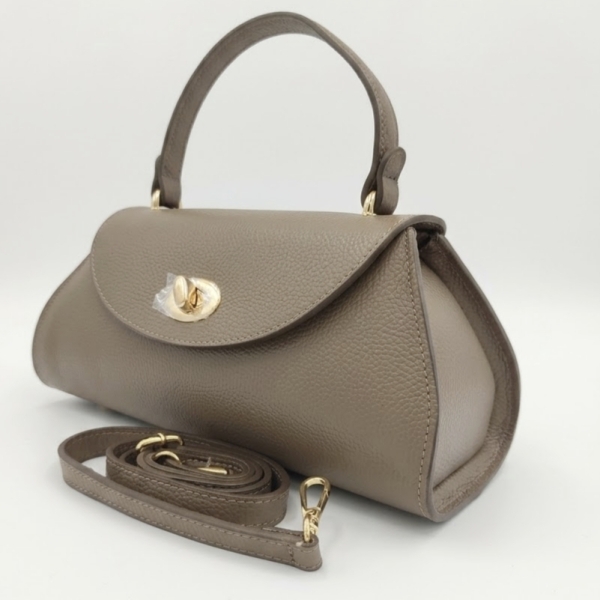 Side view of a taupe-colored Siena leather handbag, showing the trapezoidal shape and adjustable shoulder strap.