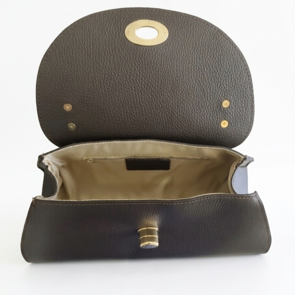 Interior of the open dark brown Siena bag, revealing the light textile lining, spacious compartment and zip pocket.