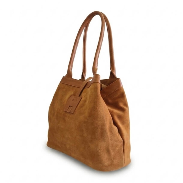 side view of a comfortable brown handbag made of genuine leather and suede, demonstrating the width of the model