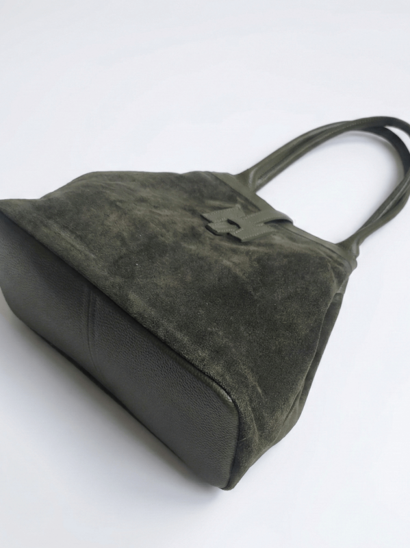 This is a bottom view of a khaki suede handbag, showcasing the sturdy bottom of smooth genuine leather.