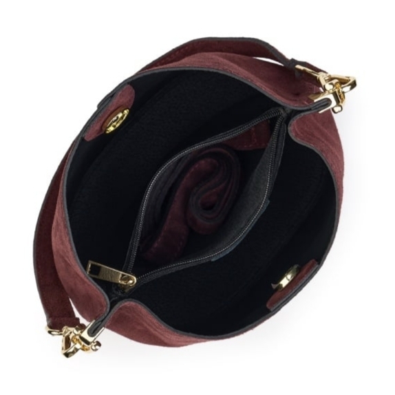 Interior and layout of a burgundy suede women's handbag with three compartments and a magnetic closure.