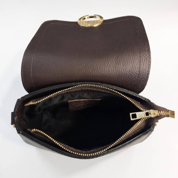 Interior of a women's leather bag featuring a main compartment, an internal zippered pocket, and gold-tone hardware.