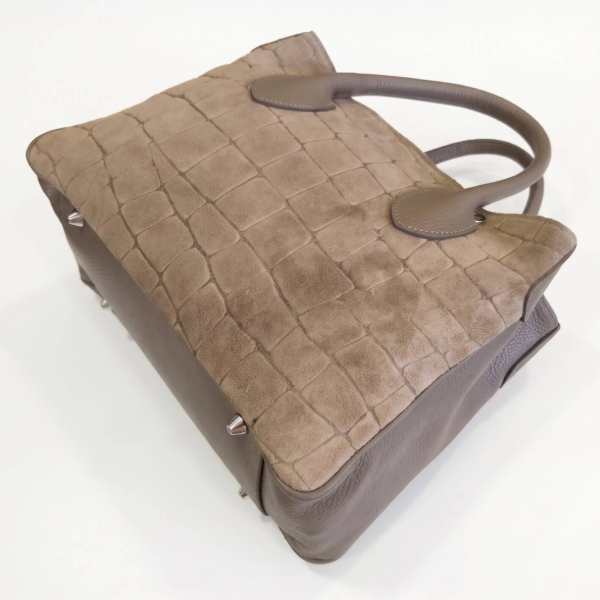 View from below and the side of a beige, taupe-colored Vera Pelle leather bag.